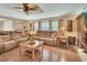 Inviting living room with hardwood floors and a ceiling fan, perfect for relaxing and entertaining guests at 435 N Oak Ave, Orange City, FL 32763