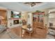 Cozy living room with a fireplace and hardwood floors offering a warm ambiance and plenty of natural light at 435 N Oak Ave, Orange City, FL 32763