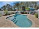 Inviting backyard oasis featuring a sparkling pool, brick paver patio, and a charming white picket fence at 435 N Oak Ave, Orange City, FL 32763