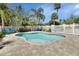 Charming backyard featuring a refreshing pool, brick paver patio, and a quaint white picket fence at 435 N Oak Ave, Orange City, FL 32763
