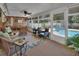 Enclosed porch with seating, dining, and a view of the pool and backyard at 435 N Oak Ave, Orange City, FL 32763