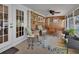 Cozy porch features wicker seating, floral rug, and shiplap walls at 435 N Oak Ave, Orange City, FL 32763