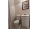 Clean bathroom with a white vanity and toilet, neutral-toned tiles, and framed mirror at 4605 Hard Rock Cv, Sanford, FL 32773