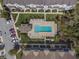 Aerial view of community pool featuring lounge chairs and parking lot nearby at 471 Portico Ct, Oviedo, FL 32765