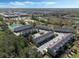 Aerial view of the community featuring a pool, townhomes, landscaping and a pond at 471 Portico Ct, Oviedo, FL 32765