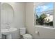 Well lit half bathroom with a pedestal sink and oval mirror at 471 Portico Ct, Oviedo, FL 32765