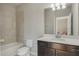 Bathroom features a vanity with black cabinets, quartz counters, and a shower-tub combination at 471 Portico Ct, Oviedo, FL 32765