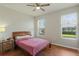 Cozy bedroom with wood floors, ceiling fan and two windows providing natural light at 471 Portico Ct, Oviedo, FL 32765