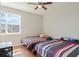 The bedroom has two twin beds with wood floors and a large window with lots of natural light at 471 Portico Ct, Oviedo, FL 32765