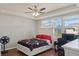Bright bedroom features a tray ceiling, wood floors, and a window with lots of natural light at 471 Portico Ct, Oviedo, FL 32765