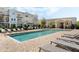 Well landscaped community pool with lounge chairs and a community building at 471 Portico Ct, Oviedo, FL 32765
