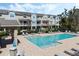 Elevated view of community pool with tables, lounge chairs and nearby buildings at 471 Portico Ct, Oviedo, FL 32765