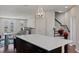 Open floorplan kitchen with island, stainless appliances and access to staircase and dining room at 471 Portico Ct, Oviedo, FL 32765