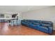 Expansive open living space with blue leather sofa and dining area with hardwood flooring at 471 Portico Ct, Oviedo, FL 32765