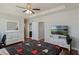 The main bedroom includes a ceiling fan, a dresser with mirror and easy access to the ensuite bathroom at 471 Portico Ct, Oviedo, FL 32765