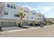 View of condo garages featuring modern townhomes with blue and beige siding at 471 Portico Ct, Oviedo, FL 32765