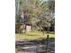 A serene backyard featuring mature trees, lush green grass, and a wooden fence at 485 Dickson Ave, Osteen, FL 32764