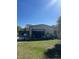 An outbuilding with an open garage door surrounded by equipment and storage at 485 Dickson Ave, Osteen, FL 32764