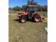 A red Kubota tractor, providing reliability for property maintenance tasks at 485 Dickson Ave, Osteen, FL 32764