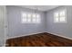 This cozy bedroom with wood flooring and plantation shutters offers a comfortable and inviting retreat at 509 Mcintosh Rd, Ormond Beach, FL 32174