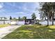 Charming single-story home with lush lawn, blue accents, and a single car garage at 509 Mcintosh Rd, Ormond Beach, FL 32174