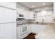 Well-lit kitchen features white cabinets, granite countertops, modern appliances, and hardwood floors at 509 Mcintosh Rd, Ormond Beach, FL 32174