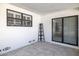 Enclosed back porch area with a tile floor, white brick, and slider window at 509 Mcintosh Rd, Ormond Beach, FL 32174