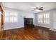 Comfortable living room with hardwood floors, a decorative fireplace, and bright, shuttered windows at 509 Mcintosh Rd, Ormond Beach, FL 32174