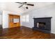 Inviting living room with hardwood floors, a fireplace, a ceiling fan and a built in cabinet at 509 Mcintosh Rd, Ormond Beach, FL 32174