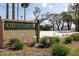 Entrance sign for Ames Park with landscaped greenery, inviting visitors to enjoy the natural beauty at 509 Mcintosh Rd, Ormond Beach, FL 32174