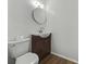 Modern bathroom with vanity, toilet, and wood look flooring at 512 Power Rd, Sanford, FL 32771