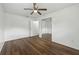 Bright bedroom with hardwood floors, ceiling fan, and mirrored closet door at 512 Power Rd, Sanford, FL 32771