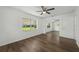 Bedroom featuring hardwood floors, closet with mirrored doors, and a window at 512 Power Rd, Sanford, FL 32771