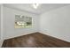 Cozy bedroom featuring hardwood floors and a well-lit window at 512 Power Rd, Sanford, FL 32771