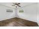 Bright bedroom featuring hardwood floors, a ceiling fan, and windows that provide natural light at 512 Power Rd, Sanford, FL 32771