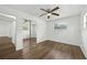 Light bedroom with hardwood floors, ceiling fan, and mirrored closet door at 512 Power Rd, Sanford, FL 32771