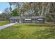 Charming single-story home featuring a well-maintained lawn and mature tree with draping Spanish moss at 512 Power Rd, Sanford, FL 32771