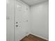 Entry hallway featuring a white door, light switch and modern laminate flooring at 512 Power Rd, Sanford, FL 32771