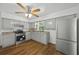 Bright kitchen with grey cabinets, stainless steel appliances, and laminate floors at 512 Power Rd, Sanford, FL 32771