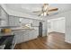Well-lit kitchen with stainless steel refrigerator, tile backsplash, and hardwood floors at 512 Power Rd, Sanford, FL 32771