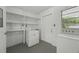 Utility room with washer, dryer, and ample shelving for storage at 512 Power Rd, Sanford, FL 32771