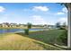 Beautiful waterfront backyard with lush lawn and stunning lake views perfect for outdoor enjoyment at 6263 W Fallsgrove Ln, Port Orange, FL 32128
