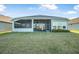 A spacious backyard with a screened-in lanai, providing an ideal outdoor living space at 6263 W Fallsgrove Ln, Port Orange, FL 32128