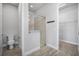 Bathroom with a glass door shower, toilet, and walk-in closet offers functionality and storage at 6263 W Fallsgrove Ln, Port Orange, FL 32128