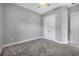 Carpeted bedroom featuring ceiling fan, closet, and paneled door offering ample storage at 6263 W Fallsgrove Ln, Port Orange, FL 32128