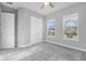 Bedroom featuring carpet, windows, ceiling fan, closet, and paneled door provides ample storage at 6263 W Fallsgrove Ln, Port Orange, FL 32128