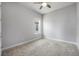 A clean, carpeted bedroom with a ceiling fan and window offers a comfortable and welcoming space at 6263 W Fallsgrove Ln, Port Orange, FL 32128