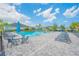 Community pool with lounge chairs, tables, and umbrellas, perfect for relaxation and recreation at 6263 W Fallsgrove Ln, Port Orange, FL 32128