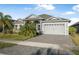 Beautifully landscaped single-story home with a two-car garage and a well-maintained lawn and driveway at 6263 W Fallsgrove Ln, Port Orange, FL 32128