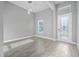 Open room with elegant wood-look tile floors and a decorative glass front door at 6263 W Fallsgrove Ln, Port Orange, FL 32128
